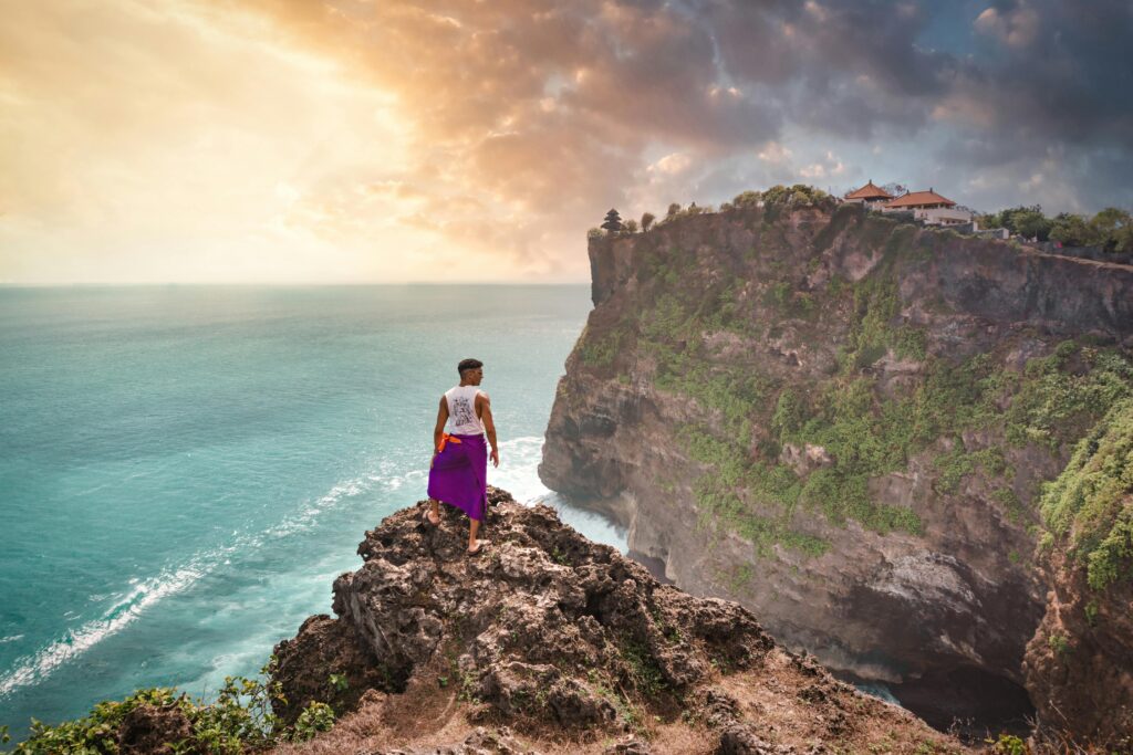 Person Standing on Rock